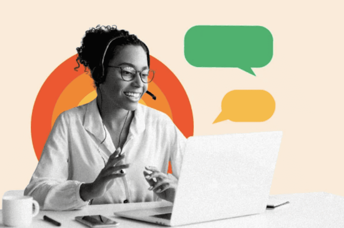 21b Consulting - A person with curly hair and glasses, wearing a headset, is seated at a desk with a laptop open. They are smiling and gesturing with a hand. There is a cup and smartphone on the desk, and green and yellow speech bubbles are in the background, indicating their role as a HubSpot Certified Partner.
